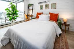 The sleeper sofa converts into a full sized bed w/4in foam mattress
Nesting tables w/ lamps
Dedicated workspace
Floor to ceiling windows
Vertical fabric room darkening blinds (Not pictured)