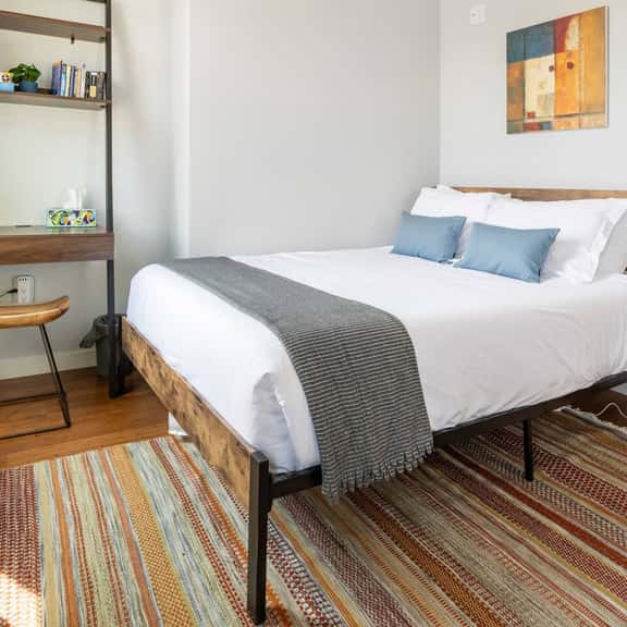 Elegant handwoven area rug, queen sized 12in thick tea memory foam mattress with luxurious bedding and pillows. 

Dedicated workspace with a stylish ergonomic seat. Cards, board games and reading for your leisure and enlightenment.
