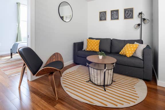 Captivating space with a modern arm chair and queen [super comfortable] sleeper sofa. It's cozy and will accommodate 4 people.