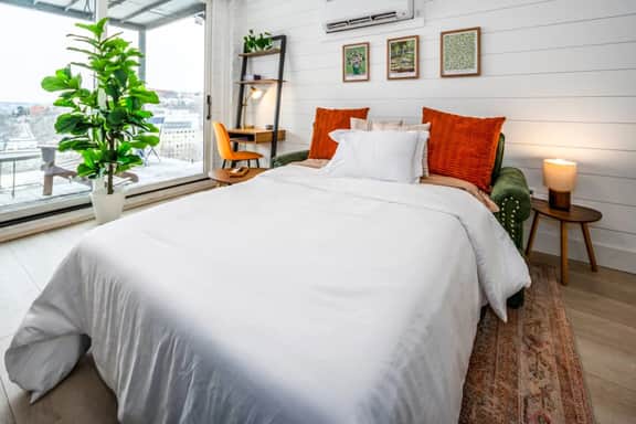 The sleeper sofa converts into a full sized bed w/4in foam mattress
Nesting tables w/ lamps
Dedicated workspace
Floor to ceiling windows
Vertical fabric room darkening blinds (Not pictured)