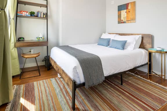 Elegant handwoven area rug, queen sized 12in thick tea memory foam mattress with luxurious bedding and pillows.
Dedicated workspace with a stylish ergonomic seat. Cards, board games and reading for your leisure and enlightenment.